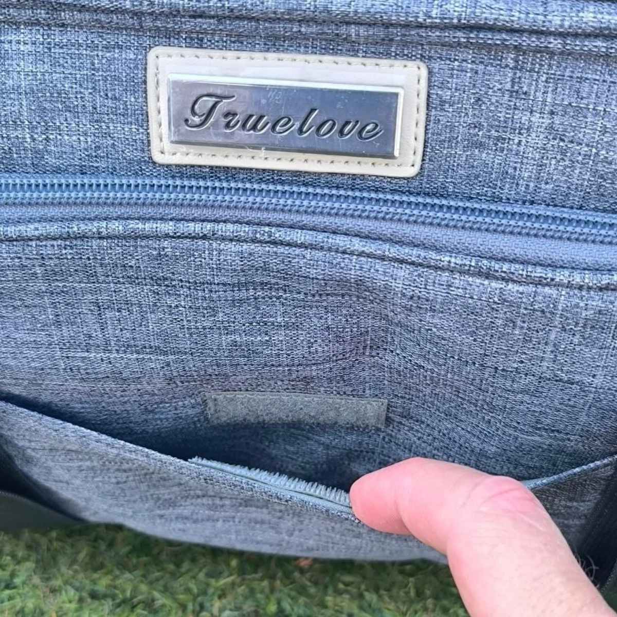 Top opening of the Nordvik pet carrier bag unzipped, showing the space inside