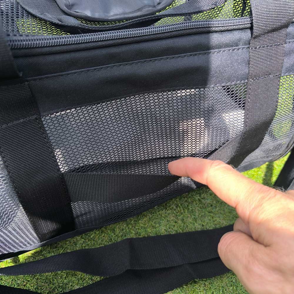 The pet bag can be attached to the handle of a suitcase